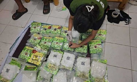 BIG CATCH. A Philippine Drug Enforcement Agency (PDEA) operative checks the shabu found by fisherfolk floating off Pangasinan waters in this undated photo. The PDEA on Monday (June 9, 2025) said the Chinese Drug Triad is behind the dumping of over one ton of shabu found by local fishermen floating in the waters of Pangasinan and Ilocos Sur. (Photo courtesy of PDEA)