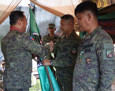 ZAMBOANGA. Major General Leonardo Peña, 11th Infantry Division commander (left), hands over the command flag of the 101st Infantry Battalion (101IB) to Lieutenant Colonel Dante Mantes (center), the newly designated 101IB commander, replacing Lieutenant Colonel Michael Demafelix (right). The Change of Command Ceremony was held Tuesday, June 10, at the headquarters of the 101IB in Lahing-Lahing village, Omar, Sulu. 