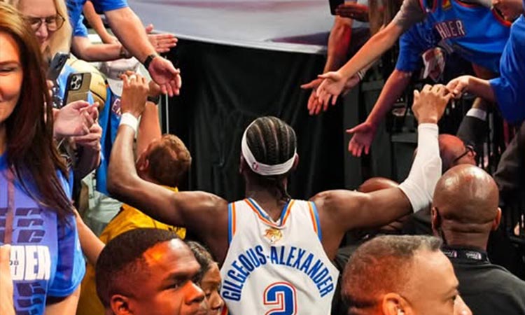 THUNDER STAR. Oklahoma City Thunder guard Shai Gilgeous-Alexander gives high-fives to a throng of enthusiastic fans while heading towards the exit after their Game 5 victory over the Indiana Pacers in the NBA Finals. / 