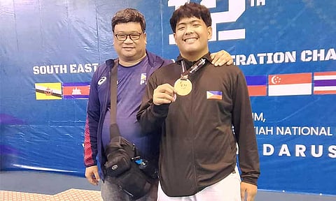 BRONZE MOMENT. Christopher Cagandahan proudly poses with Association for the Advancement of Karatedo (AAK) Davao regional director Rommel Tan after clinching bronze in the U21 +84kg Kumite at the 12th Southeast Asian Karate Federation Championship in Brunei. 