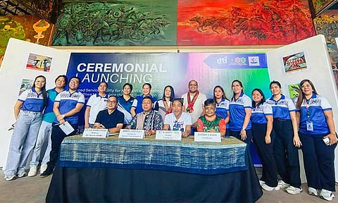 ALL TOGETHER NOW. DTI Regional Director Romeo L. Castañaga and DTI DCFO Lucky Siegfried M. Balleque, with Lawig Diwa President Kublai Millan and executive director Stella Estremera, are joined by DTI staff after the MOA signing.