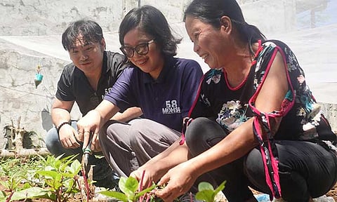 SPROUTING ACTION. MOHSG58 Chairman Jerry P. Acido (left) looks on as LPU Davao nominee Bianca Ysabel Onod (center) plants alongside a member of the Panacan Association of Women during the implementation of Project Vegstable in Barangay Panacan on June 14.