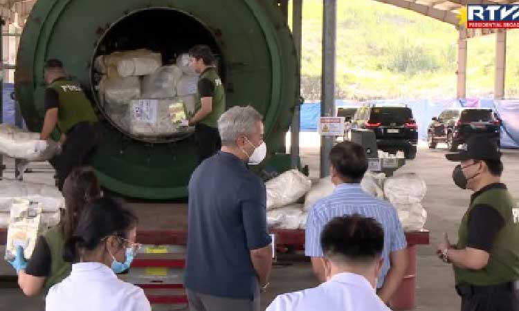 INCINERATED. President Ferdinand R. Marcos Jr. (in striped blue shirt) looks on as Philippine Drug Enforcement Agency agents ready seized illegal drugs for thermal decomposition in Capas, Tarlac on Wednesday (June 25, 2025). More than PHP9.4 billion worth of drugs, mainly methamphetamine hydrochloride or shabu, were destroyed during the activity. (RTVM screengrab)