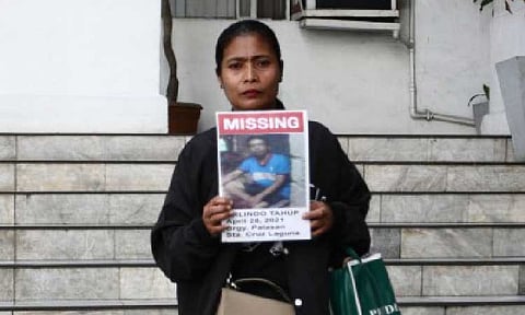 MISSING. A family member shows a picture of her relative, who is among the scores of missing sabungeros (cockfight afficionados), before a meeting with Department of Justice officials on Friday (July 5, 2025). Justice Secretary Jesus Crispin Remulla assured the families of the missing men that the DOJ is exerting all efforts to solve the case. (PNA photo by Ben Pulta)