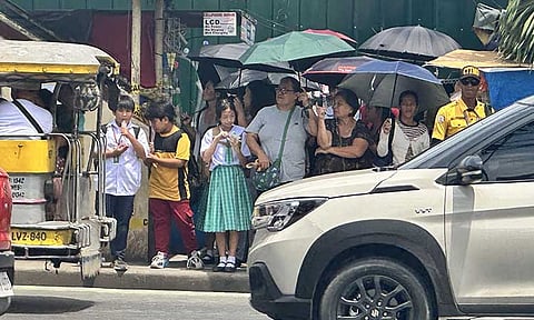 VERPASS CLOSURE. Students and parents navigate McArthur Highway on Wednesday, July 2, 2025, after the Matina Crossing overpass in Davao City was temporarily closed due to visible cracks found following the June 28 earthquake.
