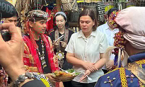 SHARING KADAYAWAN BOUNTIES. Vice President Sara Duterte eats fruits that are bountiful during Kadayawan season with foreign dignitaries and deputy mayors representing various ethnolinguistic groups of Davao on Monday, August 11, 2025, at Magsaysay Park. 
