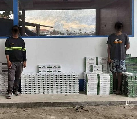 ZAMBOANGA. Maritime policemen arrest two individuals as they seized some P1.6 million worth of contraband in a law enforcement operation on Friday, August 15, in Sta. Catalina village, Zamboanga City. 
