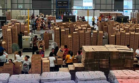 DISASTER RESPONSE. Volunteers help repack family food packs at the Department of Social Welfare and Development’s (DSWD) National Resource Operations Center in Pasay City in this undated photo. As of Wednesday (Aug. 20, 2025), the DSWD has distributed 2,612,529 family food packs to families affected by recent disasters. (Photo courtesy of DSWD)