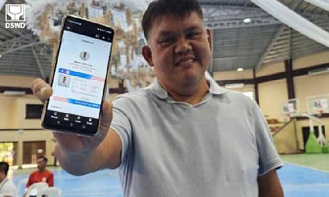 UNIFIED PWD ID. Alberto Dela Cruz, president of the Samahan ng mga may Kapansanan sa San Miguel, Inc., is all smiles as he shows his digital persons with disabilities identification (ID) card during the pilot rollout of the unified PWD ID in San Miguel, Bulacan on Aug. 12, 2025. The DSWD said Thursday (Aug. 28) the old PWD IDs issued by the local government units are still honored while the unified ID system is still in the pilot stage. (Photo courtesy of DSWD)