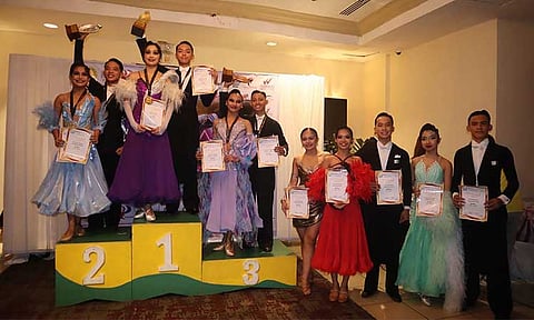 DAZZLING DUO. Bhenz Owen Semilla and Francheska Darvin of Davao City, second pair from left,  show off their Under-21 Standard category champion’s trophy and medal haul from the WDSF Open & PDSFI 3rd Quarter National DanceSport Championship at Waterfront Cebu City Hotel, adding one gold and two silver to their growing list of achievements.