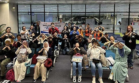 SALUTE. Smiles, gratitude and salute welcomes returning OFWs at the Ninoy Aquino International Airport. (Photo courtesy of Department of Migrant Workers)
