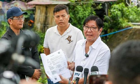 ‘BIG FISH’. President Ferdinand R. Marcos Jr. shows the media a copy of a report on the PHP55.7-million reinforced concrete river wall project in Baliwag City, Bulacan on Aug. 20, 2025. In his latest podcast episode aired Monday (Sept. 8), he promised that the government’s crackdown on anomalous flood control projects will not end until the “big fish” behind the schemes are held accountable. (PCO photo)