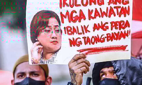 ACCOUNTABILITY SOUGHT. A protester holds a poster with a photo of government contractor Cezarah Discaya during an anti-corruption rally in Quezon City on Sept. 13, 2025. Two major gatherings are set in Manila and Quezon City on Sunday (Sept. 21, 2025). (PNA photo by Joan Bondoc)