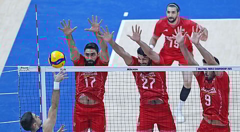 DEFENSE. Iran players rise for a solid block against a Serbian spiker on their way to a 23-25, 25-19, 24-26, 25-22, 15-9 comeback win that booked them a quarterfinal berth in the FIVB Volleyball Men’s World Championship.