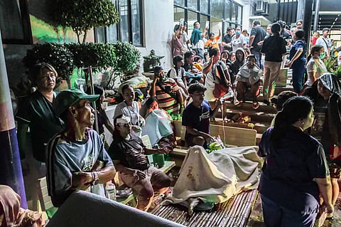 CEBU. Patients and residents gather outside a hospital in northern Cebu after the magnitude 6.9 earthquake forced evacuations, with medical staff attending to the injured amid fears of aftershocks.