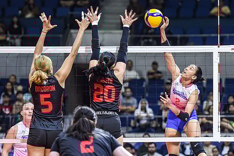 POWERSPIKE. Alyssa Valdez of Creamline spikes past Petro Gazz defenders Mary Joy Capocong Dacoron and Jonah Sabete during their PVL Reinforced Conference match at the Smart Araneta Coliseum on Tuesday night.