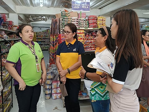 PRICE MONITORING. Department of Trade and Industry (DTI) personnel monitor prices of commodities at a business establishment in quake-hit Daval Oriental.