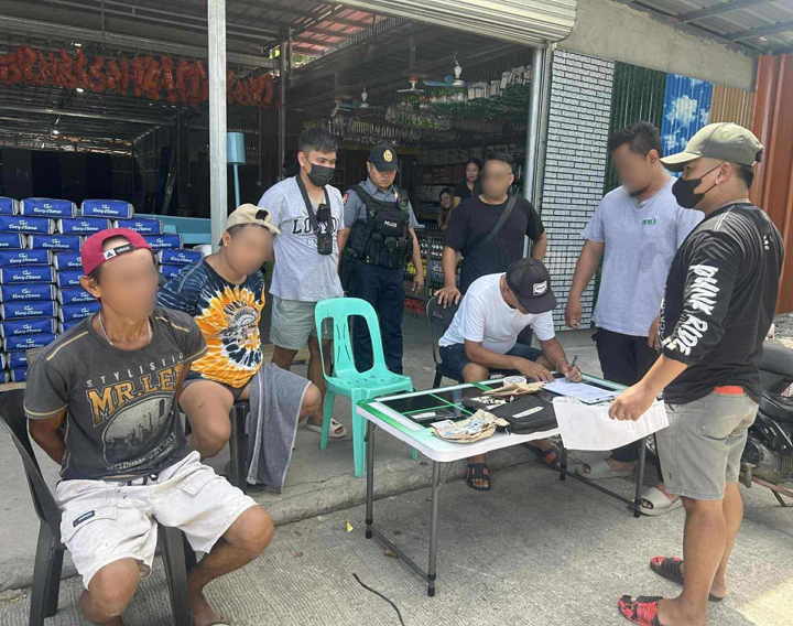 ZAMBOANGA. Lawmen arrest two high-value targets (seated left and 2nd from left) and seize some P680,000 worth of illegal drugs and a firearm in an anti-drug operationon Friday, October 17, in Mukas village, Kolambugan, Lanao del Norte. 