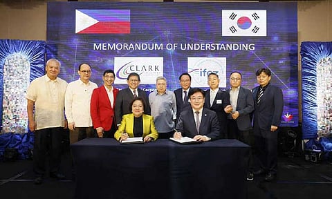 CDC President and CEO Atty. Agnes VST Devanadera (seated, left) and IFEZ Commissioner Wonsok Yun (seated, right) lead the ceremonial signing of the Memorandum of Agreement between CDC and IFEZ. Joining them are (from left, standing) CDC Director Jose Philip Panlilio, Governance Commission for Government-Owned and Controlled Corporations Chairperson Atty. Marius Corpus, OSAPIEA Undersecretary Joee Guilas, CDC Chairperson Atty. Edgardo Pamintuan, CDC Director Atty. Pablo de Borja, Namjong Chairperson Lee Yul Gi, Besco Clark Philippines Group of Companies Corporation President Im Yee Gon,
IFEZ Deputy Director Hyuk Choi and IFEZ Assistant Director Sangho Lee. (CDC Photo) 