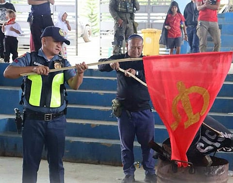 ZAMBOANGA. Participants of the united peace rally on Monday, December 1, burn the flags of the Dawlah Islamiya-Maute Group (DI-MG) and the Communist Party of the Philippines–New People’s Army–National Democratic Front (CPP-NPA-NDF) as the Sangguniang Bayan of Binidayan, through a resolution, declares the municipality free from the influence of DI-MG and the CPP-NPA-NDF. 