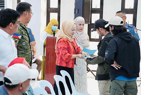 ZAMBOANGA. Isabela City Mayor Sitti Djalia Turabin-Hataman, chairperson of the Local Amnesty Board–Basilan (center), on Monday, December 1, leads the issuance of Safe Conduct Passes to 54 amnesty applicants, protecting them from arrest or prosecution while their applications are pending approval. 