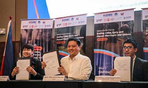 SAFER PATHS FOR GIRLS. Department of Social Welfare and Development (DSWD) Undersecretary Eduardo Punay (from left), DSWD Secretary Rex Gatchalian, and Representative of DSWD-Cordillera Administrative Region Jerry Julian hold copies of the National Action Plan to End Child, Early, Forced Marriages and Unions for 2025–2028 during its launch in Quezon City on Friday (Dec. 12, 2025). It aims to prevent child marriage, improve protection services, and address deep-rooted social norms that place children, particularly girls, at risk. (Photo courtesy of United Nations Population Fund)