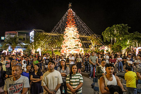 Mandauehanons attend the Misa de Gallo outside the National Shrine of St. Joseph after the church reaches full capacity.
