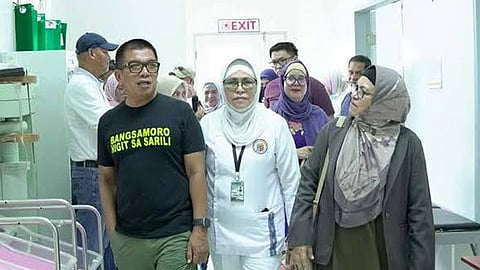 ZAMBOANGA. Basilan Governor Mujiv Hataman (left), accompanied by health officials, tours the facilities of Sumisip District Hospital after leading the activation of the solar power project on Thursday, December 18. 