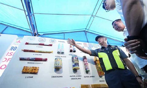LEGAL FIRECRACKERS. Acting Philippine National Police chief Lt. Gen. Jose Melencio Nartatez Jr. points to samples of legal firecrackers and pyrotechnic products during an ocular inspection in Barangay Turo, Bocaue, Bulacan on Dec. 22, 2025. The activity promotes public awareness on approved fireworks and enforces safety and regulatory compliance ahead of the holiday season. (PNA photo by Robert Oswald P. Alfiler)