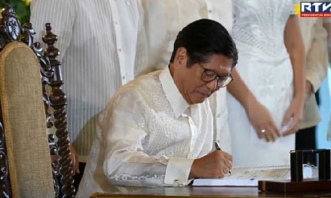 2026 BUDGET SIGNED. President Ferdinand R. Marcos Jr. signs the PHP6.793-trillion 2026 national budget into law on Monday (Jan. 5, 2026), vetoing several unprogrammed items to tighten fiscal discipline. Under Republic Act 12314 or the General Appropriations Act (GAA) of 2026, education gets the biggest share at PHP1.345 trillion, while healthcare receives a record PHP448.125 billion and agriculture, PHP297.102 billion. (RTVM screengrab)