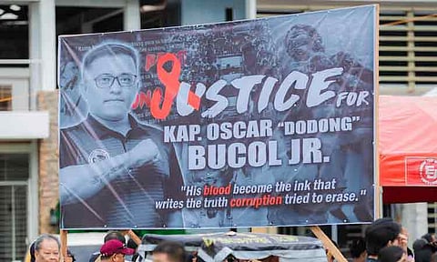 A poster calling for justice for the late Tres de Mayo Barangay Captain Oscar “Dodong” Bucol Jr. is seen during a gathering at the Brgy. Tres de Mayo Rizal Avenue Memorial Park in Digos City, Davao del Sur, 40 days after his death on January 4, 2026. Family members and supporters came together to honor and remember the slain official, who was killed by unidentified assailants during a livestream.