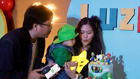 QUIBRANZA CREW. The Quibranza family — Luis Quibranza III, Luzio Franco Quibranza and Febe C. Quibranza — gather to blow out the birthday candle, a snapshot of hands-on, joyful parenting that has shaped a meaningful first year.