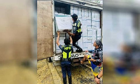 CONTRABAND. Highway Patrol Group personnel inspect a delivery truck filled with suspected smuggled cigarettes in Basay, Negros Oriental on Oct. 11, 2025. Philippine National Police acting chief Lt. Gen. Jose Melencio Nartatez Jr. on Sunday (Jan. 25, 2026) ordered a thorough investigation to arrest those involved in bankrolling large-scale cigarette smuggling operations. (Photo courtesy of HPG-Negros Oriental)