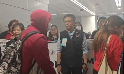 HOME AGAIN. Migrant Workers Secretary welcomes the 190 repatriated overseas Filipino workers (OFWs) at the Ninoy Aquino International Airport Terminal 1 in Pasay City on Thursday (Feb. 5, 2026). The OFWs were rescued from scam hubs in Cambodia. (Photo screengrab from DMW Facebook page)
