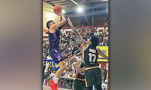 AIRBORNE ASSAULT. Mighty Warriors’ Raffy Celis (left) pulls up for a fadeaway jumper over the outstretched arm of Tiger Ship Builders’ Kent Ariar during their 2026 Cebu City Charter Day Cup elimination round encounter at the City Sports Institute. Celis chipped in 15 points to help the Warriors secure a narrow 82-80 victory. / 