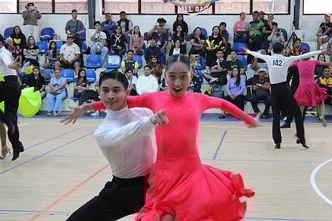 DAZZLING DUO. John Terence Cuizon and Angel Jane P. Tinambacan of Doña Carmen Denia National High School (DCDNHS) wow the judges with their performances, capturing six gold medals in the dancesports competition at the 2026 Davao Region Athletic Association (Davraa) Meet at the Davao del Norte Sports and Tourism Complex in Tagum City, Monday evening, February 23.