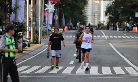 FIT AND HEALTHY. Joggers enjoy car-free Tomas Morato in Quezon City in this undated photo. The Department of the Interior and Local Government (DILG) on Tuesday (March 10, 2026) urged local government units to organize community fitness activities, expand green public spaces, and adopt car-free Sundays to promote active and healthy lifestyles among residents. (Photo grabbed from the QC government website)