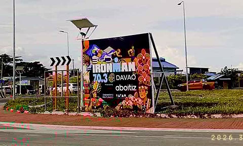 A tarpaulin promoting the upcoming IRONMAN 70.3 Davao is displayed at the rotonda along Roxas Coastal Road on Thursday, March 12, 2026, as the city prepares to host the international triathlon from March 20 to 22.