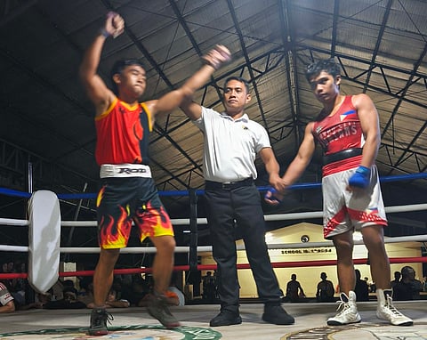 SPLIT VICTORY. A referee raises Rodolfo M. Galinato III’s hand after he secured a split-decision victory over Joshua Morano in the boys’ 60-kilogram bout at the 89th Araw ng Dabaw DCABA Boxing Competition at Bolton Elementary School on March 14.