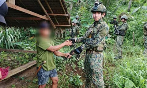 SURRENDER. A New People's Army (NPA) rebel turns over a firearm to the Regional Mobile Force Battalion 8 (Eastern Visayas) in Mondragon, Northern Samar on Jan. 25, 2026. The Armed Forces of the Philippines reported that 446 NPA rebels and supporters surrendered from Jan. 1 to March 26, 2026, while 18 were arrested and 18 were killed in operations nationwide. (Photo courtesy of RMFB-8)
