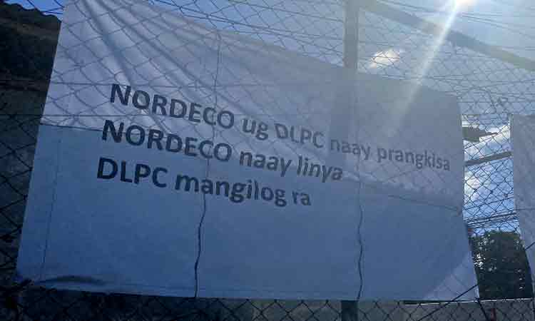 Tarpaulins are displayed outside a substation of the Northern Davao Electric Cooperative Inc. (Nordeco) in Tagum City, highlighting its claim over transmission lines amid its franchise overlap with Davao Light and Power Company. The signage alleges that while both entities hold franchises, Nordeco owns the transmission lines, which Davao Light is “taking over.” Davao Light officially assumed control of four key Nordeco substations in Tagum City and Asuncion, Davao del Norte, on Wednesday, March 25, 2026.