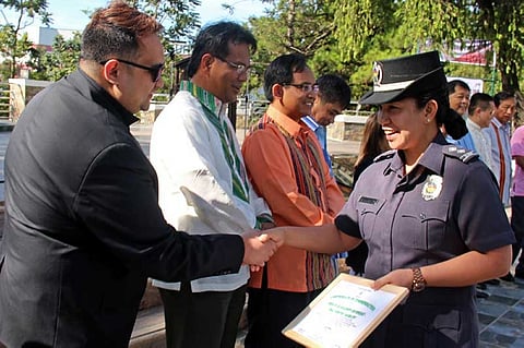 RED ORCHID AWARDEE. Baguio City Jail Female Dormitory  jail warden Senior Inspector April Rose Ayangwa  receives a commendation from city officials as a Red Orchid Awardee having garnered 91-100 percent  score based on the Department of Health criteria in implementing 100 percent tobacco-free environment. (Photo by Bong Cayabyab)