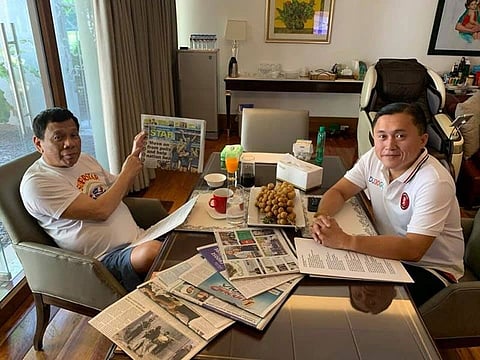 MANILA, In this photo posted by probable senator-elect Christopher Go on his Facebook account on Sunday, May 19, President Rodrigo Duterte points to the front page of a newspaper as proof of life amid rumors to he was rushed to the hospital. (File Photo)