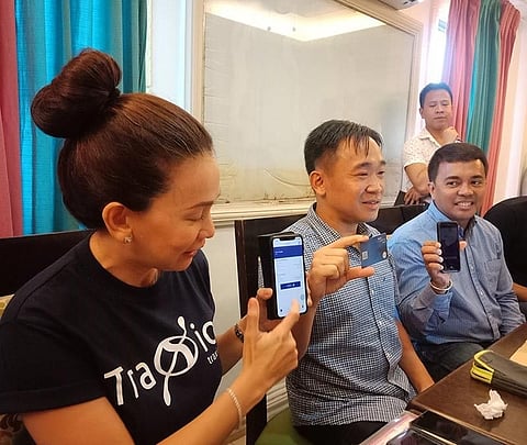 DAVAO. (From left) TraXiaon on CEO Ann Cuisia, NCCC CEO Lafayette Lim and NCCC chief financial officer Sonny Catacutan show the Ka-Coop Card and its mobile application. (Lyka Casamayor)