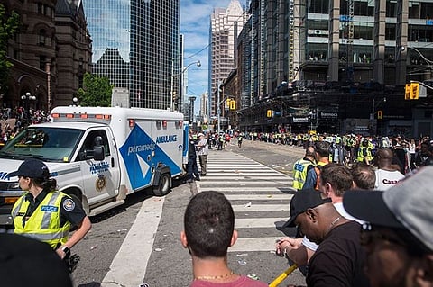 CANADA. An ambulance arrives to the scene after shots were fired during the Toronto Raptors NBA basketball championship victory celebration near Nathan Phillips Square in Toronto, Monday, June 17, 2019. (AP)