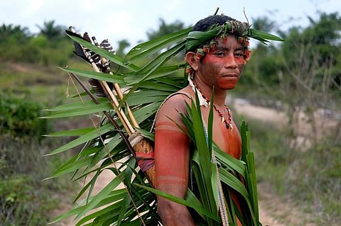BRAZIL. Indigenous Tembe warrior Ronilson Tembe poses for a portrait on the Alto Rio Guama indigenous reserve as he waits for police to arrive with other members of his tribe in Para state, Brazil, Wednesday, September 4, 2019. Tembe men sometimes daub themselves in traditional war paint and patrol the forest. They carry bows and arrows, but feel increasingly vulnerable as they brace for run-ins with illegal loggers. (AP)