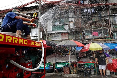 MANILA. A fireman sprays disinfectant along a road in Manila, Philippines on Wednesday, March 11, 2020. For most people, the new coronavirus causes only mild or moderate symptoms, such as fever and cough. For some, especially older adults and people with existing health problems, it can cause more severe illness, including pneumonia. (AP)