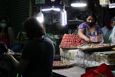 BAGUIO. A vendor sells strawberries at the Baguio Public Market at rock bottom prices since the Luzon-wide enhanced community quarantine. Transport of goods from the highlands to markets in the lowlands has been a struggle. Strawberries are being sold for as low as P100 in the public market. (Photo by Jean Nicole Cortes)
