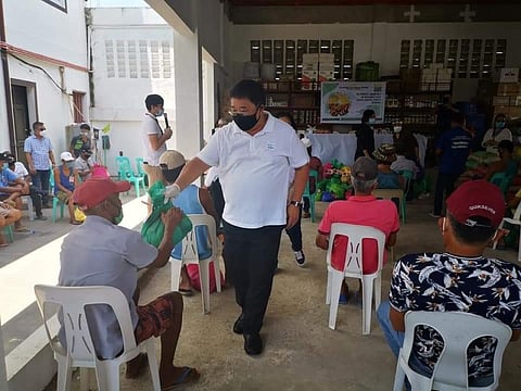 PAMPANGA. Agrarian Reform Secretary John Castriciones leads the distribution of relief. (Contributed photo) 