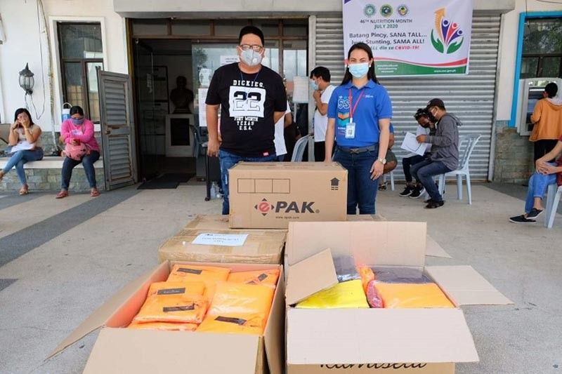 PPEs FOR MABALACAT CITY. Jane Garcia of Texas Instruments handed over some 350 pieces of personal protective equipment (PPE) to Glen Tiongco of the Mayor's Office to be given to the city's frontliners against Covid-19. These PPEs were made by Kamiseta. (Mabalacat CIO)